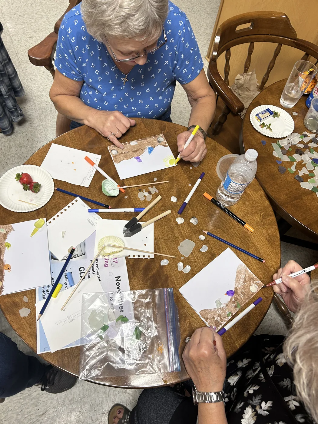Participants making sea glass cards at a workshop by Joy Designs