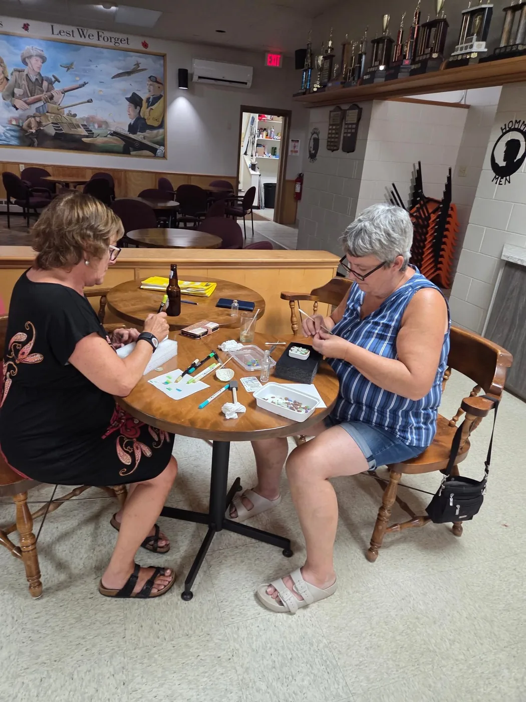 A group creating sea glass cards around a workshop table by Joy Designs