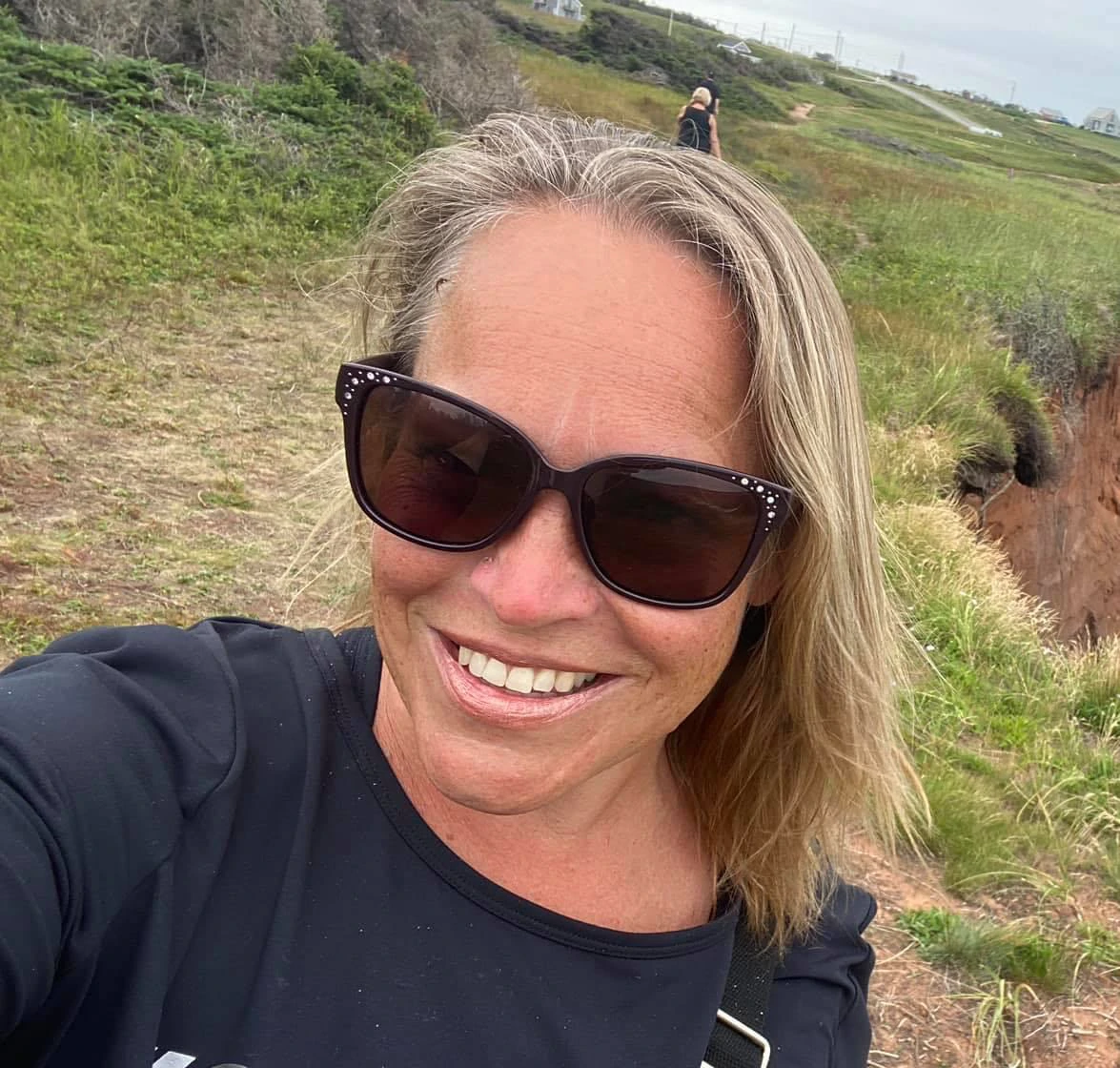 Diana Tutty smiling on a PEI coastal walk