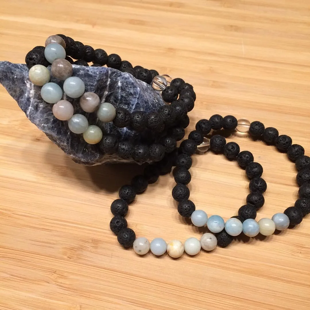 Black and blue bead bracelets with a stone by Nora Cummins, Energy Intuitive