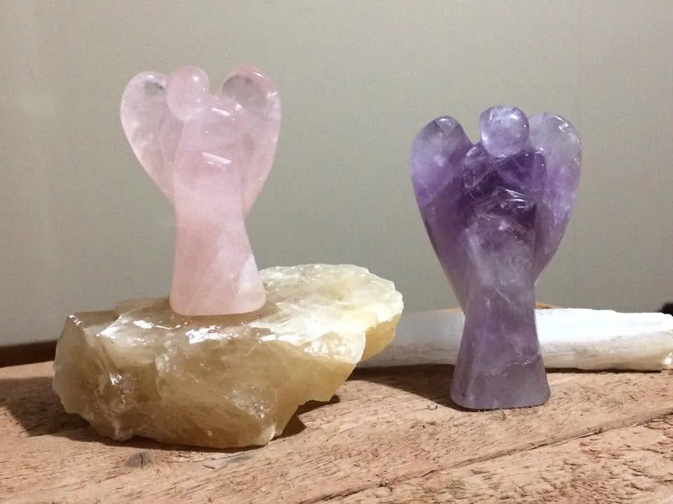Crystal angels, one standing on a stone by Nora Cummins, Energy Intuitive