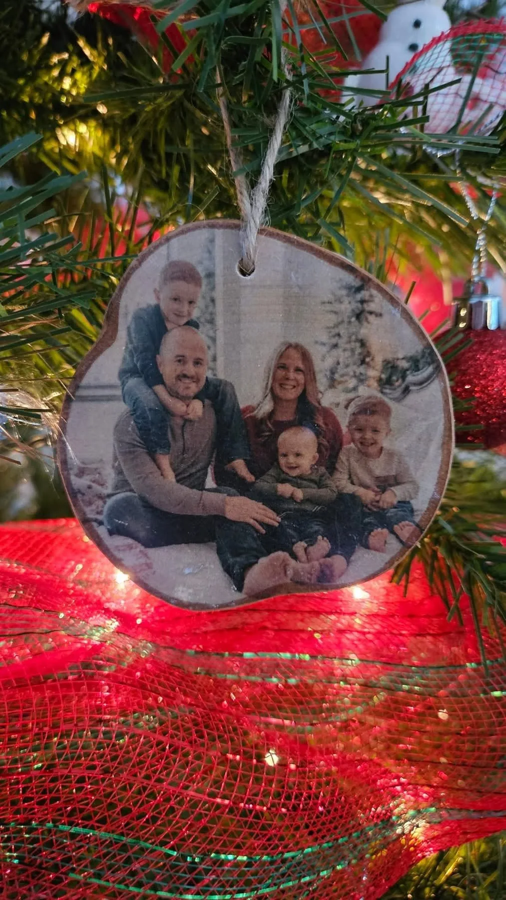 Personalized family photo ornament on a Christmas tree by Photo Ornaments