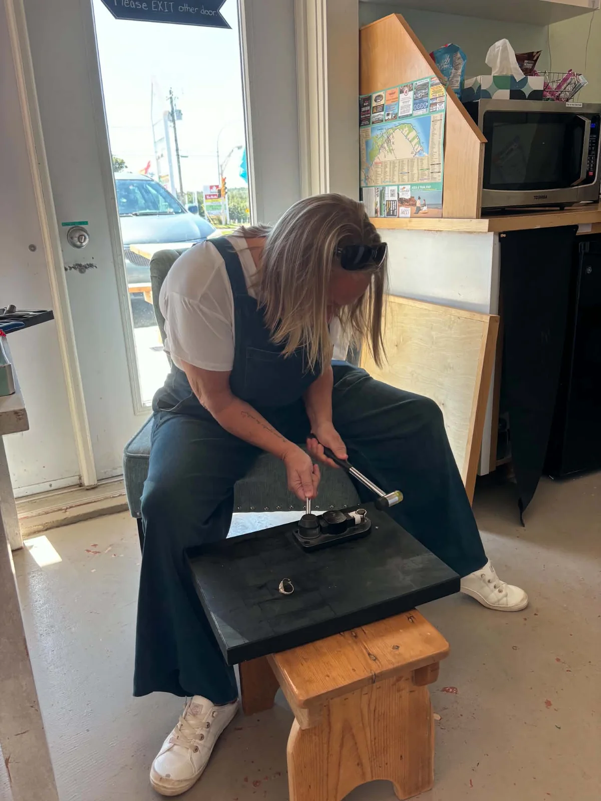 Diana Tutty shaping vintage flatware at her workbench