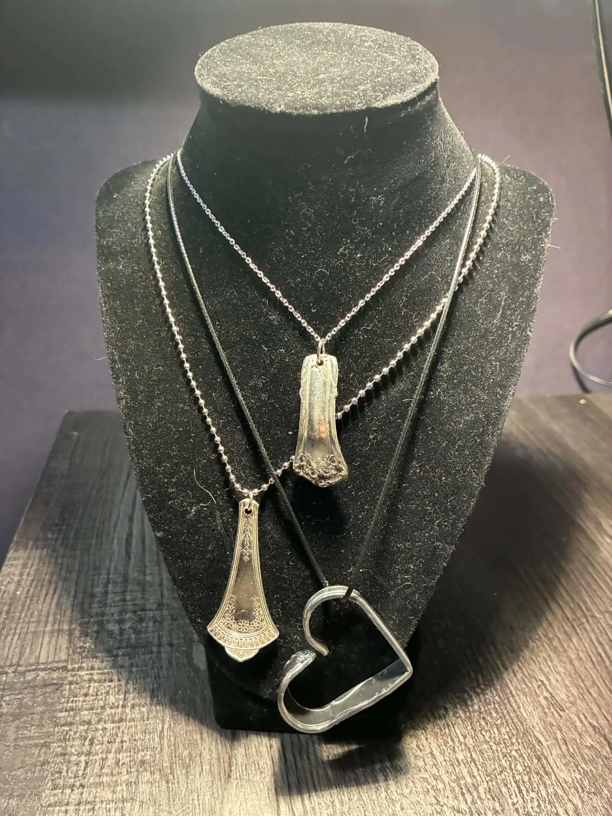 Vintage flatware necklaces on a black jewellery stand by Vintage Curve
