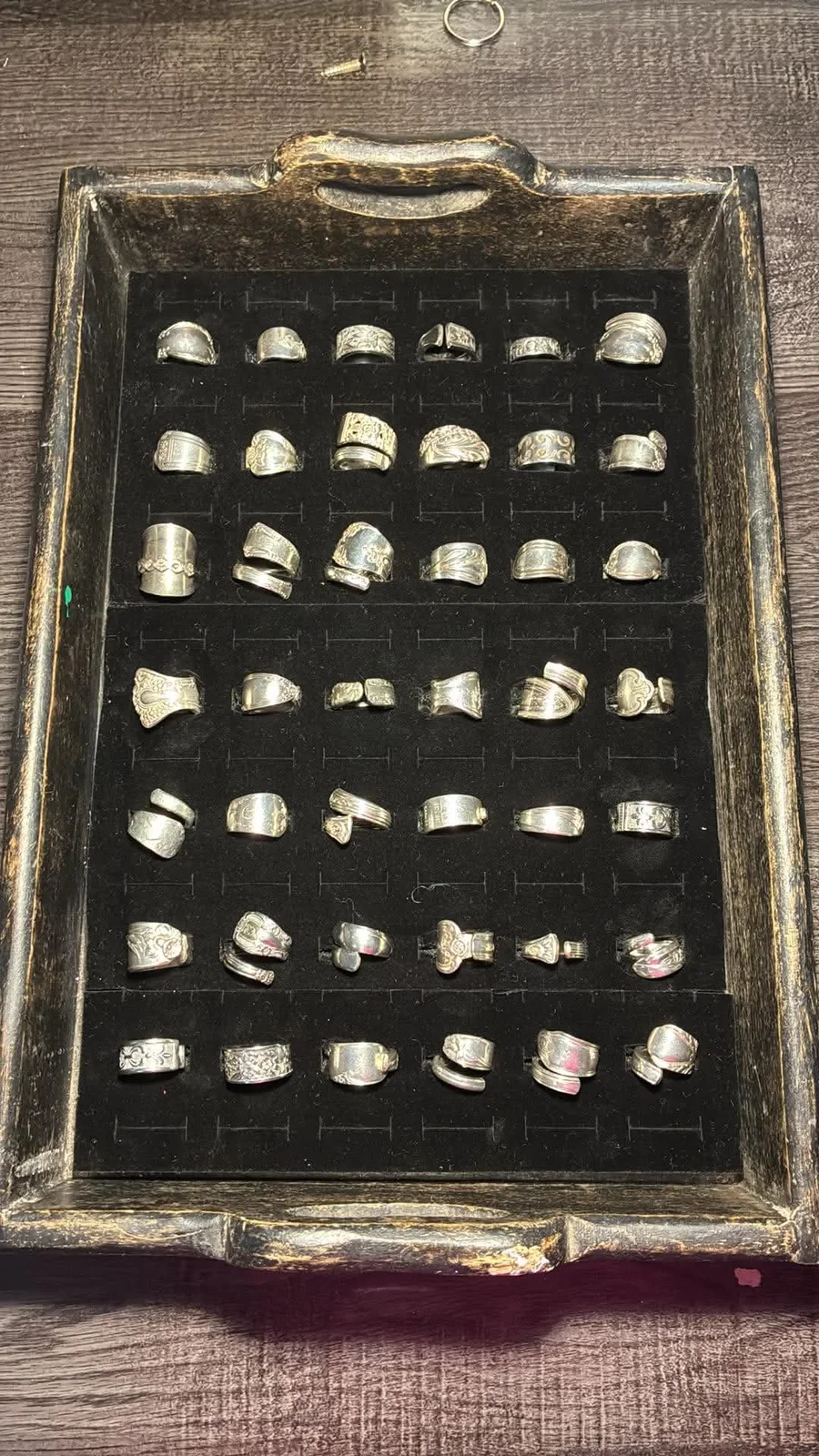 Vintage spoon rings arranged in a display case by Vintage Curve